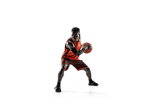 Full length portrait of a basketball player with a ball isolated on white studio background. advertising concept. Fit african american athlete with ball. Motion, activity, movement concepts.
