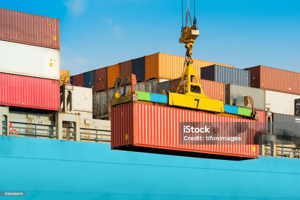 Cargo ship being loaded with containers Cargo ship being loaded with containers at port in Chile Container Stock Photo