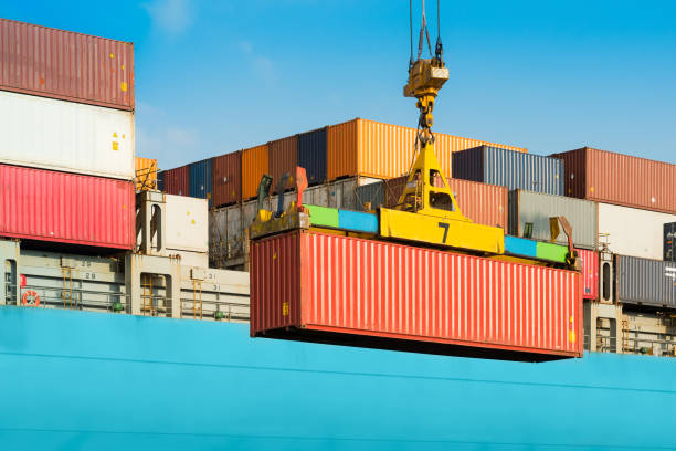 Cargo ship being loaded with containers Cargo ship being loaded with containers at port in Chile cargo container stock pictures, royalty-free photos & images