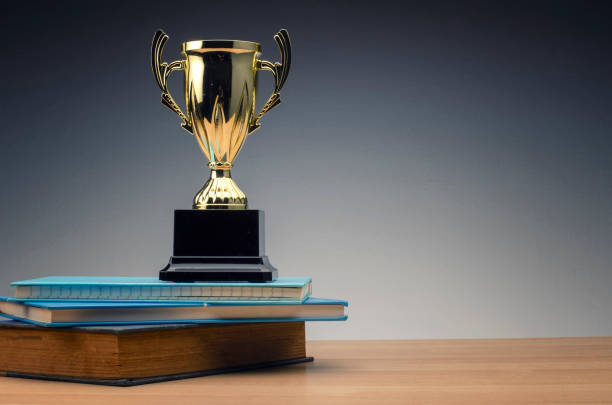 istock trophy on stack of book for education success concept. 1135320683