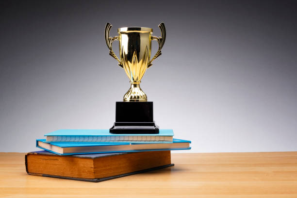 istock trophy on stack of book for education success concept. 1135320690