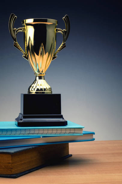 istock trophy on stack of book for education success concept. 1135320713