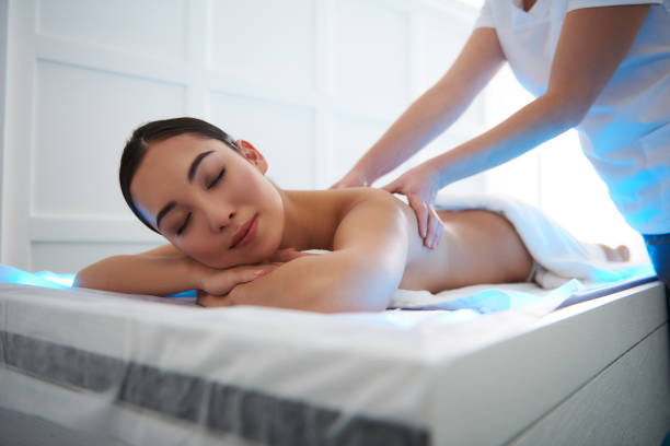 istock Smiling asian lady having massage in spa salon 1135320743