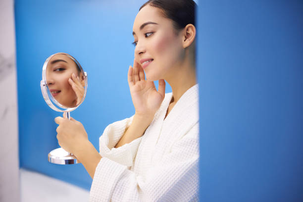 istock Happy young lady look at mirror after procedure 1135320785