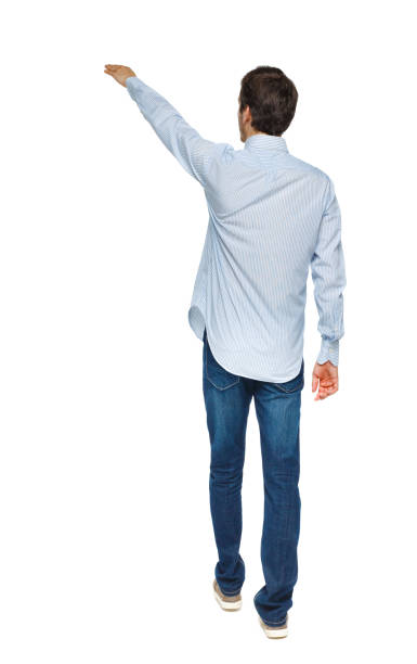 istock Back view of a man walking with a pointing hand 1135321172