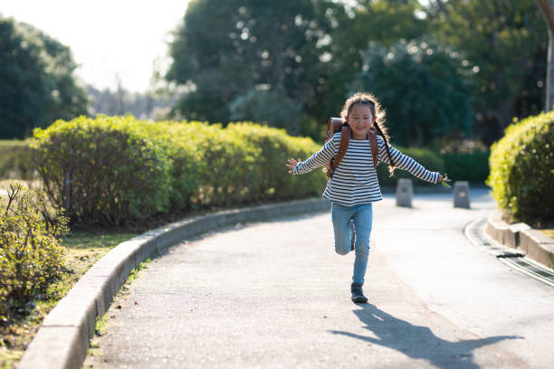 istock Girl carrying a school bag 1135321748