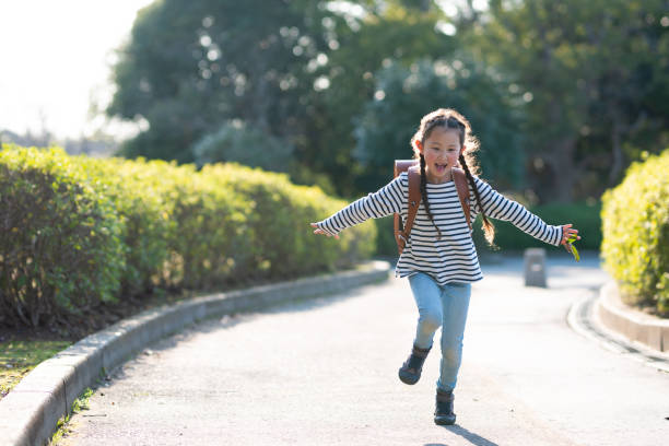 девушка с школьной сумкой - walking girl стоковые фото и изображения