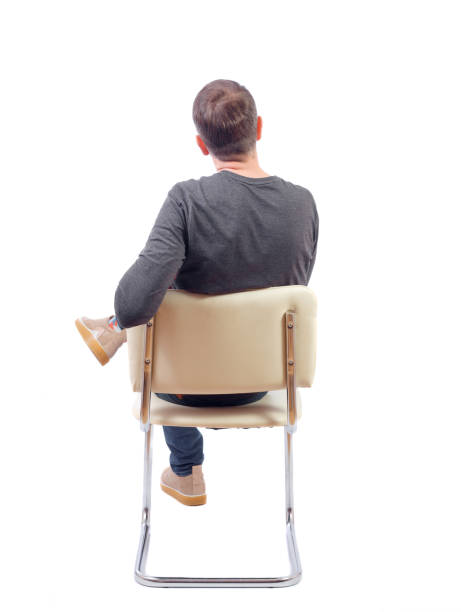 istock Back view of a man sitting on a chair. 1135322311