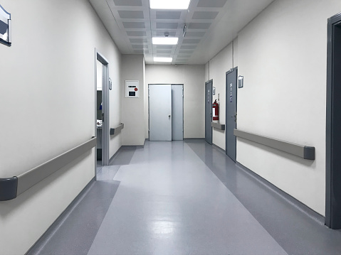 Empty modern corridor in hospital with bright light background. Interior design concept