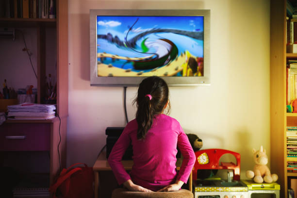 Small Girl is Watching a Cartoon stock photo