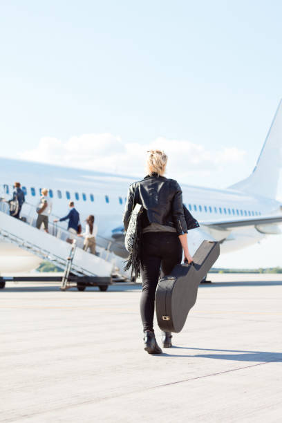istock Female musician boarding a plane 1135324423