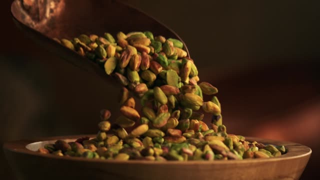 pistachios falling into a bowl