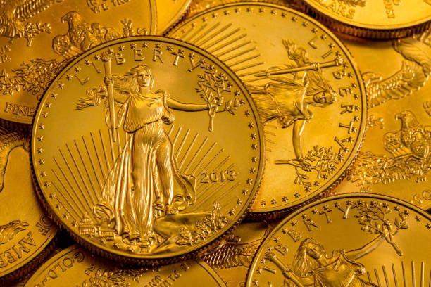 Pile of US Treasury Gold Eagle one ounce coins Pile of golden coins with Liberty on US Treasury issue Gold Eagle one ounce pure gold coin ounce stock pictures, royalty-free photos & images