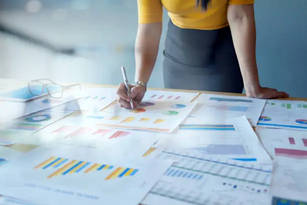 Photo of Female Accountant or Marketing Check report documents