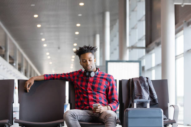 istock African man waiting for flight in airport lounge 1135325021