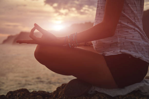 istock Young woman practicing yoga - meditation on the beach. 1135325859