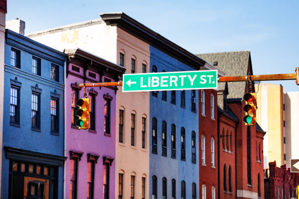 istock Guide sign at Baltimore street with colored houses 1135327658