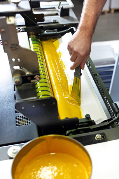 istock Offset printing. The printer adds yellow paint 1135327994