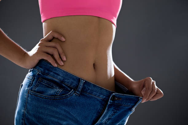istock woman loses weight 1135329504