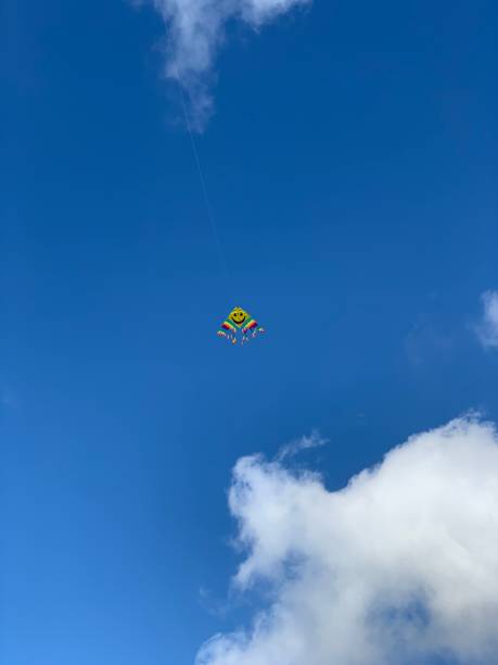 istock Flying kite in the sky with clouds 1135330318