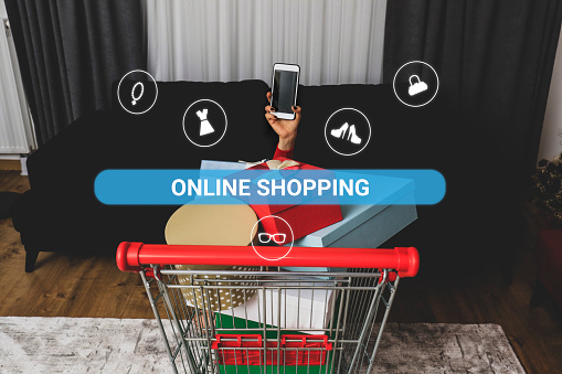 Woman hand holding smartphone and shopping cart