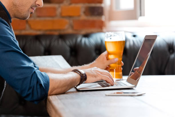 istock Businessman using laptop at table in brewery 1135331529