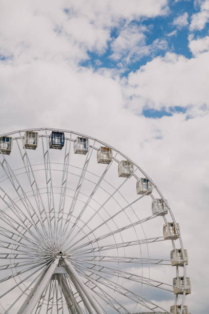 istock Ferris wheel on background of cloudy sky 1135332995