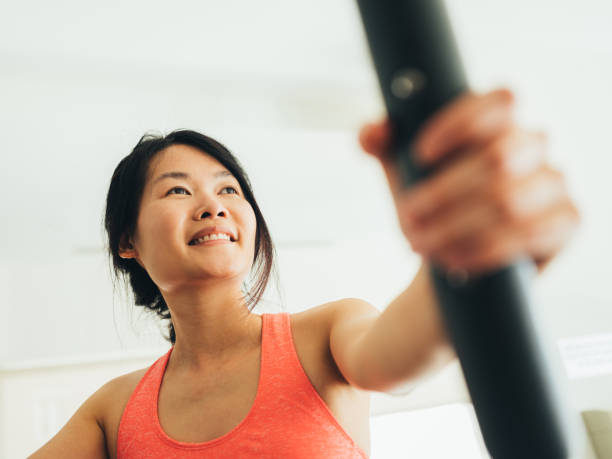 istock Young Asian woman working out 1135334820