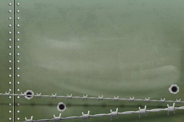 istock Metal background with holes from bullets and barbed wire. 1135336162