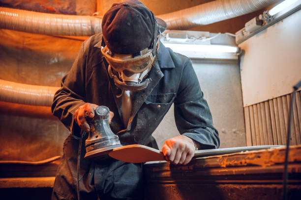 istock Carpenter using circular saw for cutting wooden boards. 1135339736