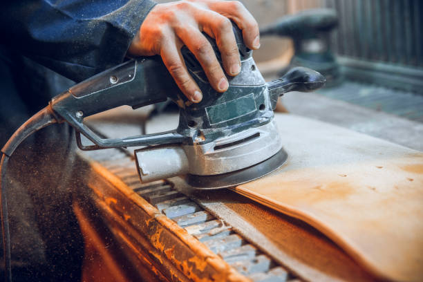 istock Carpenter using circular saw for cutting wooden boards. 1135339737