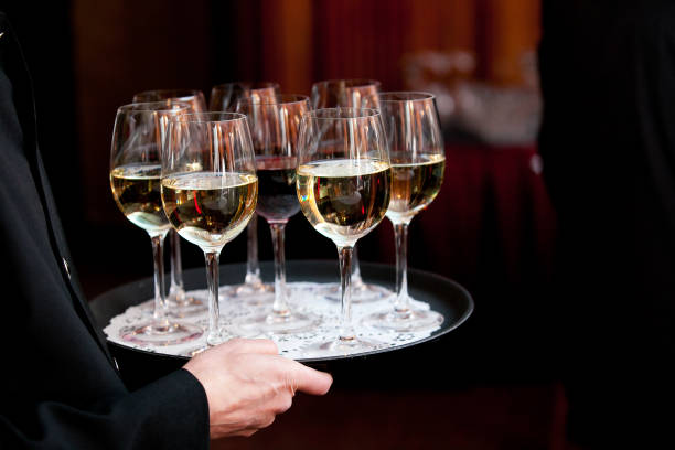 istock A waiter holding a tray full of drinks during a catered wedding or other special event 1135340830