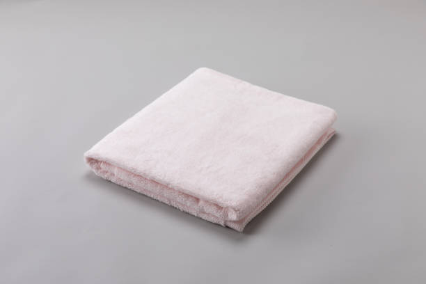 istock pink single towel folded on gray background 1135340859
