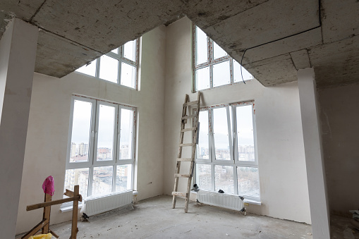 The interior of the first floor in a two-story apartment in a new building