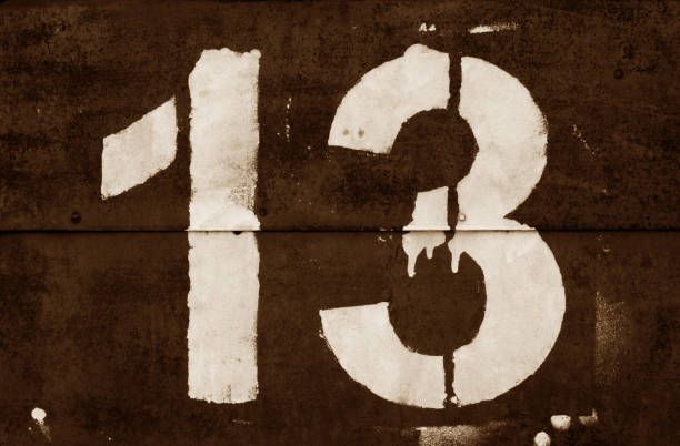istock Number 13 in stencil on metal wall in brown tone. 1135344019