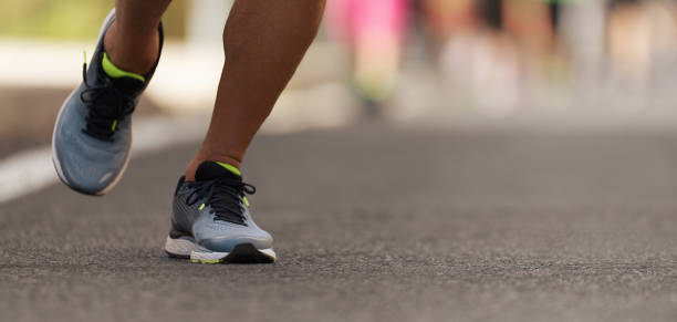 istock Runners feet running on road close up on shoe 1135345024
