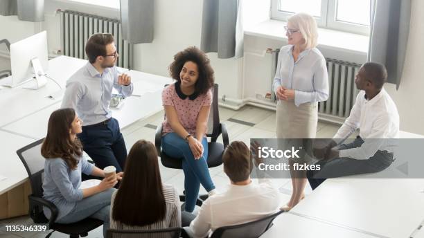 Business People Group Discussing Work Plan With Coach At Meeting Stock Photo - Download Image Now