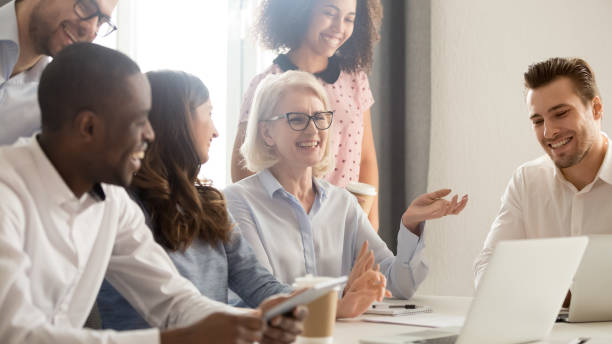 istock Smiling happy multicultural office employees colleagues laughing together 1135346389