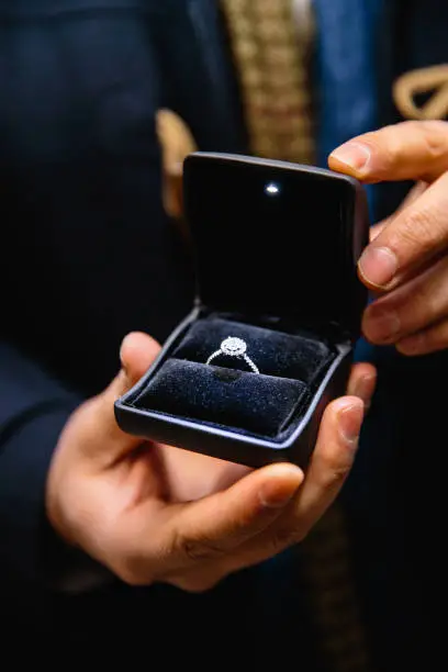 Real life proposal - beautiful engagement ring with shiny diamonds and bright crystal gems