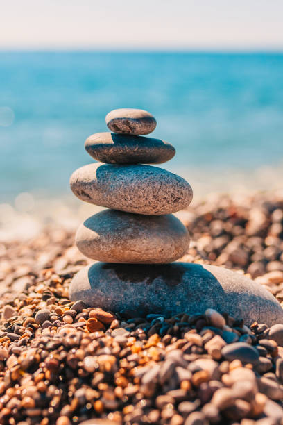 istock Smooth large sea pebbles are stacked on the seashore - Zen Concept 1135347508