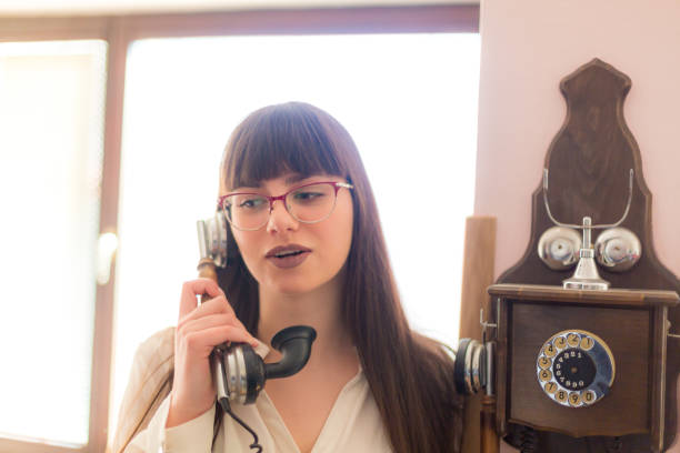 istock Woman using old phone, it is time to communicate 1135348188