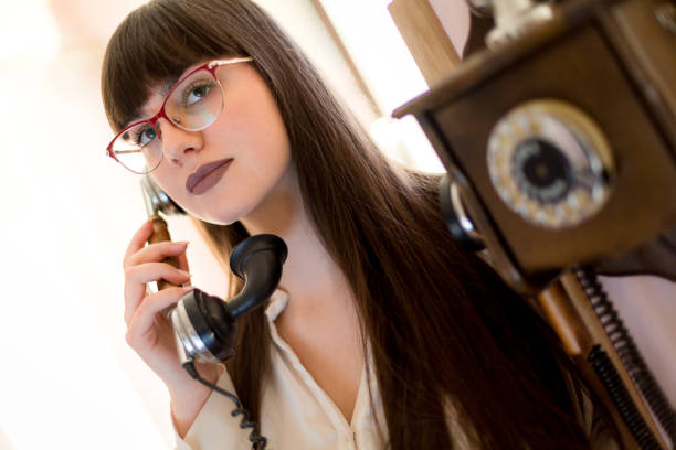 istock Woman using old phone, it is time to communicate 1135348199