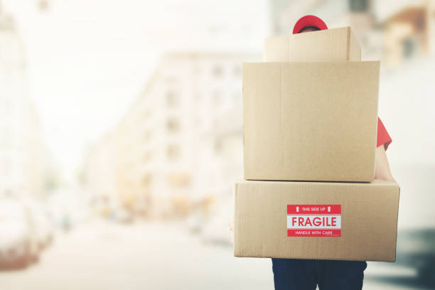 istock delivery man with stack of boxes standing on the street. copy space 1135348406