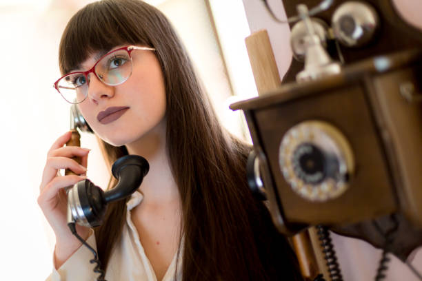 istock Woman using old phone, it is time to communicate 1135348495