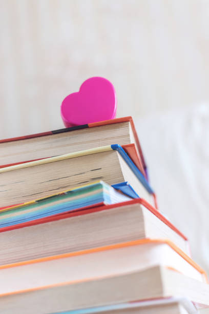 istock Stack of books and pink heart on the white bed. Education background with Copy space, back to school concept 1135348566