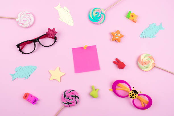 istock Festive funny celebration background with paper fish, sticky note and decor on pink background. All Fools' Day, humor, prank, joke concept 1135349386