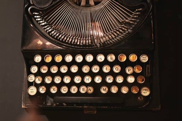 vieille machine à écrire d'en haut sur le fond noir - typewriter typebar retro revival old photos et images de collection