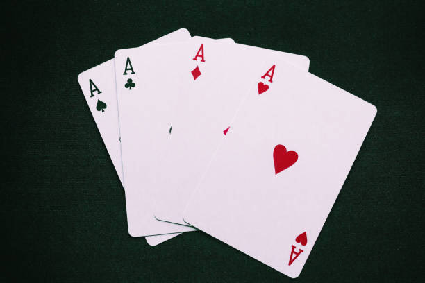 istock four aces on a green background closeup 1135352227