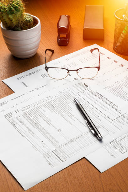 istock US tax forms on the table with the eyeglasses, pen and cactus 1135352506