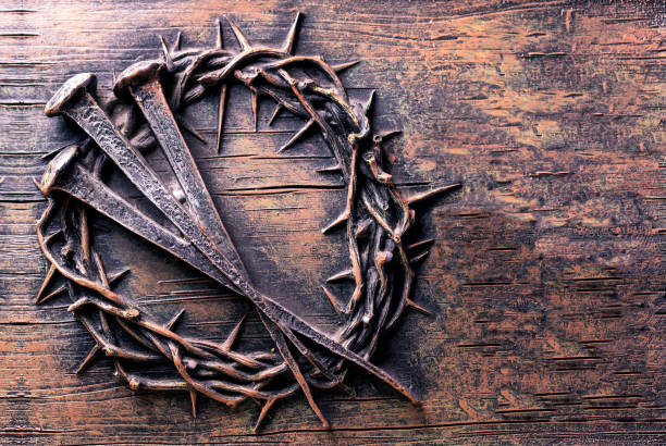 Crown of thorns and nails engraved on stone stock photo